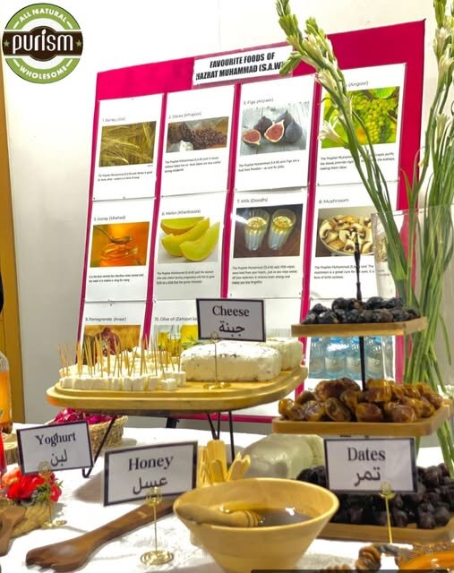 Purism stall display of cheese, honey, dates and yoghurt at a community food exhibition